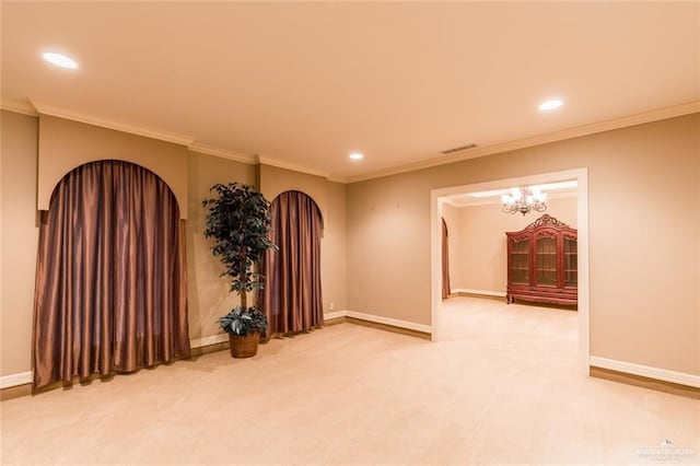 unfurnished room with carpet floors, baseboards, and arched walkways