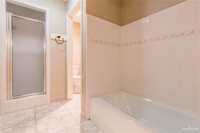 full bathroom featuring marble finish floor, a tub to relax in, a stall shower, and toilet