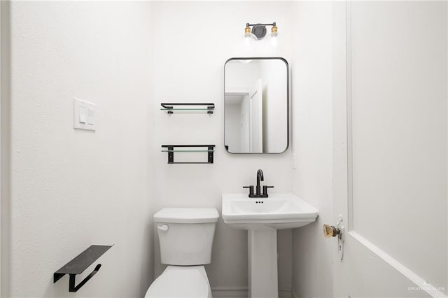 bathroom with sink and toilet