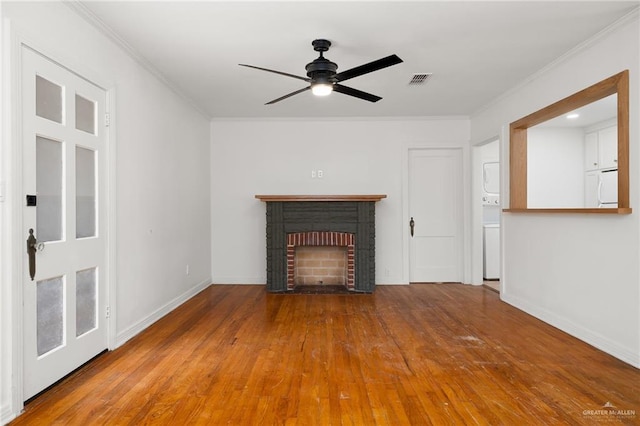 unfurnished living room with hardwood / wood-style floors, ceiling fan, ornamental molding, and a brick fireplace