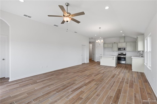 unfurnished living room with a sink, visible vents, and recessed lighting