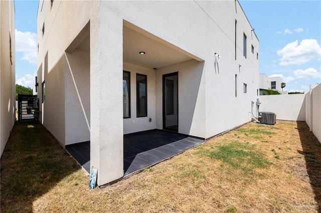 exterior space with a patio area, a yard, and central AC unit