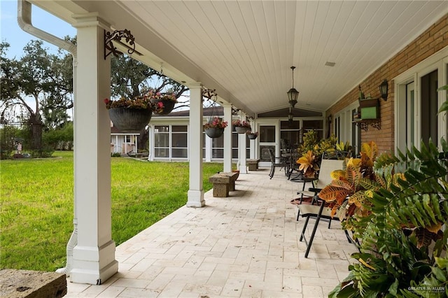 view of patio featuring a sunroom