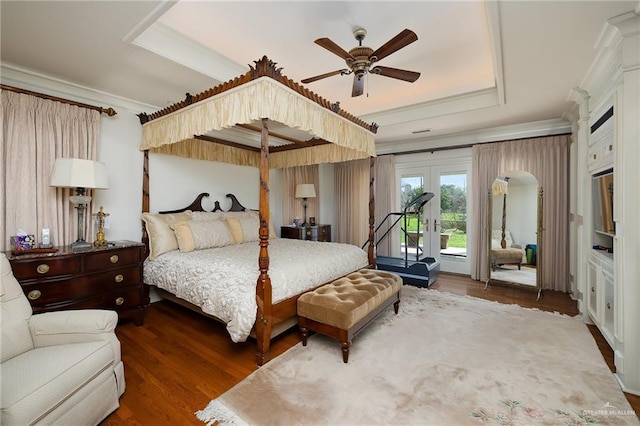 bedroom with ornamental molding, dark hardwood / wood-style flooring, a raised ceiling, ceiling fan, and access to exterior