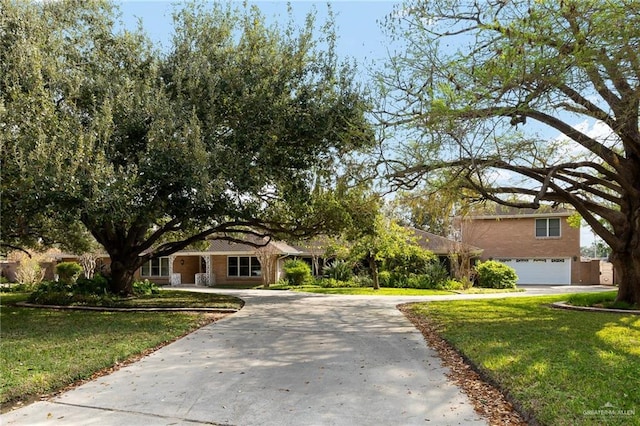 view of front of home featuring a garage and a front lawn