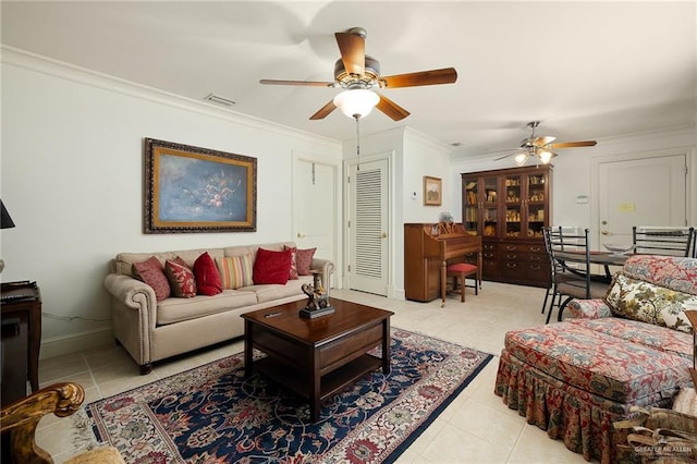 living room with ceiling fan, ornamental molding, and light tile patterned floors