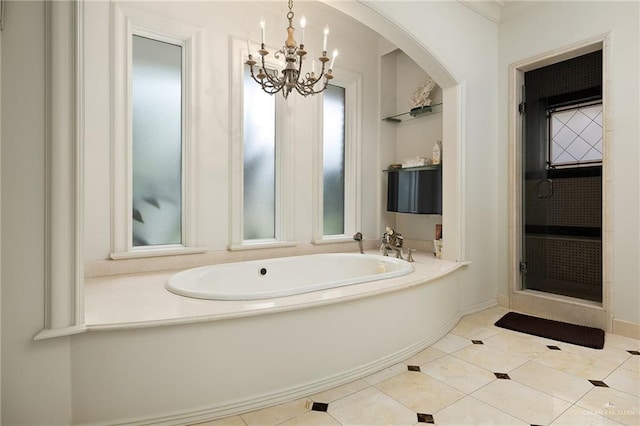 bathroom with a tub, tile patterned floors, and an inviting chandelier