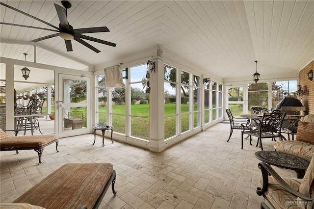 sunroom featuring vaulted ceiling, wooden ceiling, and ceiling fan