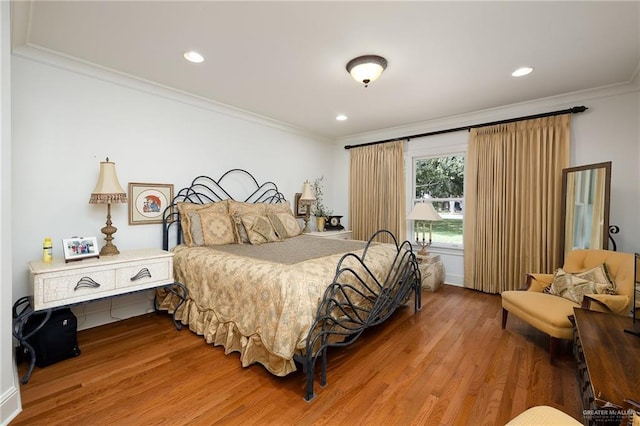 bedroom with hardwood / wood-style flooring and ornamental molding