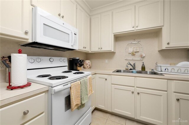 kitchen featuring white cabinetry, sink, white appliances, and light tile patterned floors