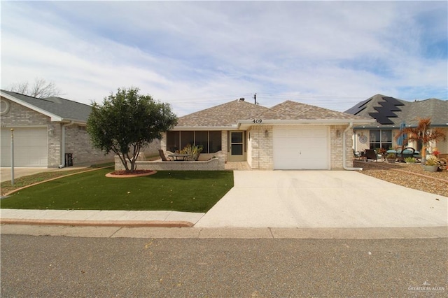 ranch-style home with a garage and a front lawn