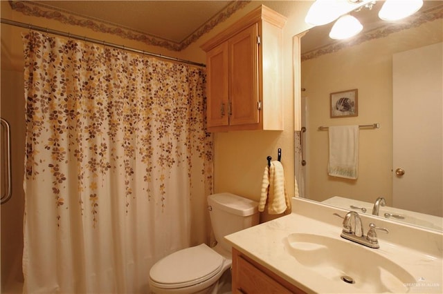 bathroom featuring vanity, walk in shower, and toilet