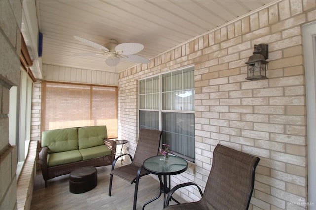 sunroom featuring ceiling fan