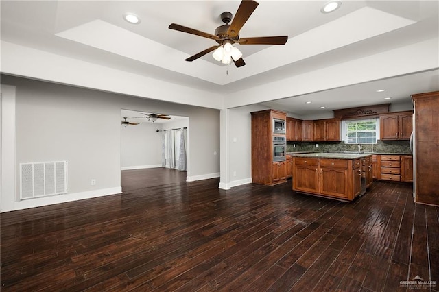 904 S Diplomat Dr, Pharr, TX 78577 - kitchen with appliances with stainless steel finishes, a tray ceiling, open floor plan, dark wood finished floors, and ceiling fan
