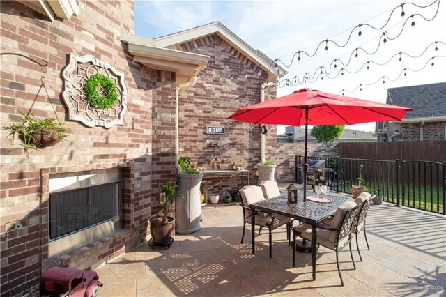 14616 Kurth Cv, Mcallen, TX 78504 - view of patio / terrace featuring an outdoor brick fireplace, fence, and outdoor dining area