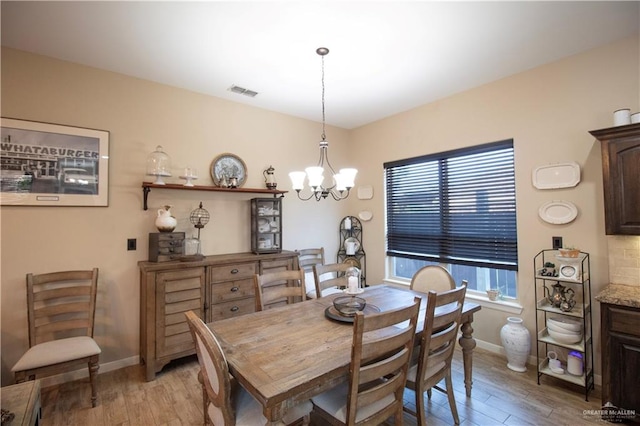 14616 Kurth Cv, Mcallen, TX 78504 - dining space featuring a chandelier, light wood-style flooring, and baseboards