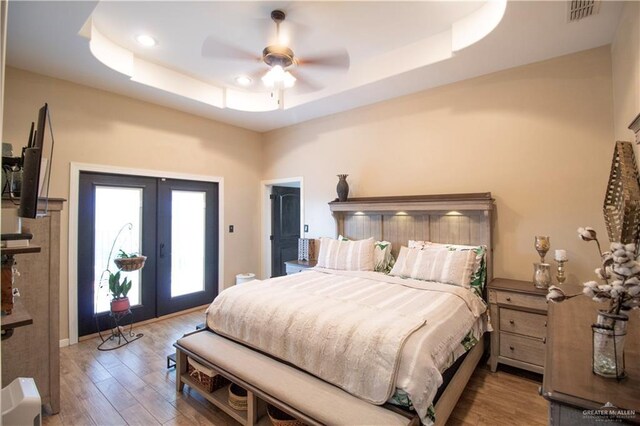 14616 Kurth Cv, Mcallen, TX 78504 - bedroom featuring a tray ceiling, french doors, access to outside, wood finished floors, and a ceiling fan