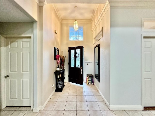 tiled foyer entrance featuring crown molding