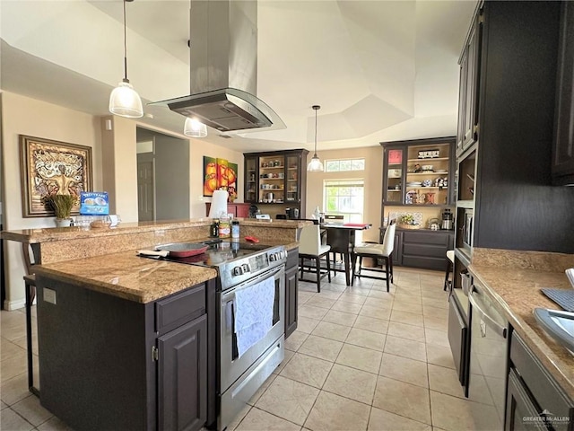 kitchen with island range hood, hanging light fixtures, stainless steel appliances, a kitchen island, and a tray ceiling