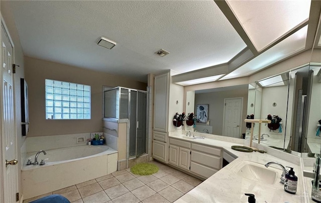 bathroom featuring tile patterned flooring, a textured ceiling, independent shower and bath, and vanity