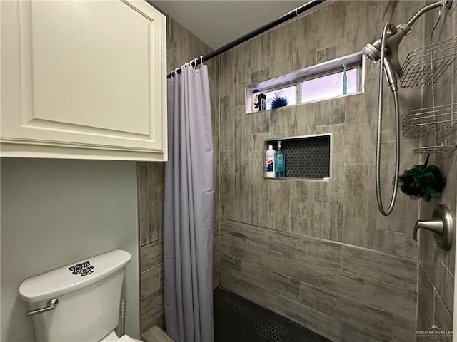 bathroom featuring toilet and a shower with shower curtain