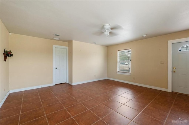 12612 E Clark Rd, La Feria, TX 78559 - empty room featuring ceiling fan, dark tile patterned floors, and baseboards