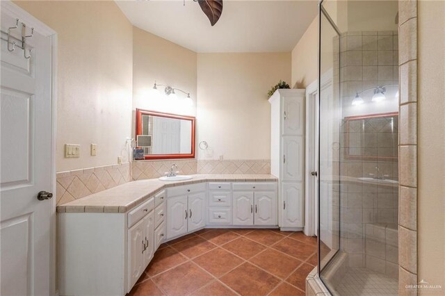 12612 E Clark Rd, La Feria, TX 78559 - full bathroom featuring a shower stall, vanity, decorative backsplash, and tile patterned flooring