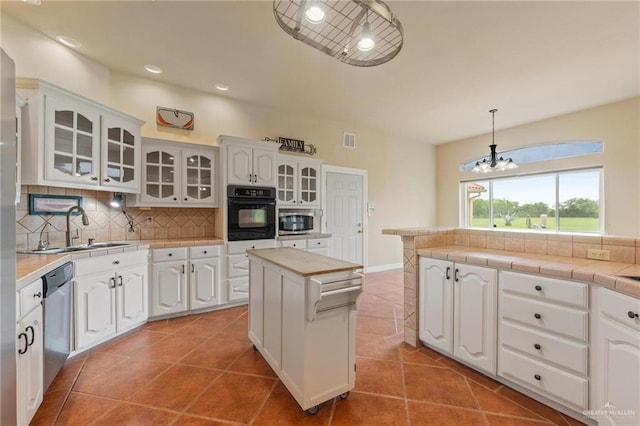 12612 E Clark Rd, La Feria, TX 78559 - kitchen featuring stainless steel appliances, a sink, backsplash, white cabinetry, and glass insert cabinets