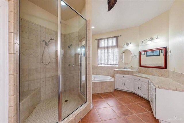 12612 E Clark Rd, La Feria, TX 78559 - full bathroom with tile patterned flooring, a shower stall, a garden tub, vanity, and recessed lighting