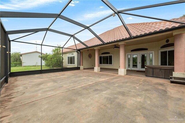 12612 E Clark Rd, La Feria, TX 78559 - rear view of house featuring french doors, a patio, a tile roof, a hot tub, and a ceiling fan