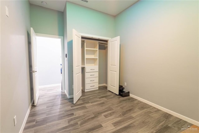 unfurnished bedroom featuring hardwood / wood-style flooring and a closet