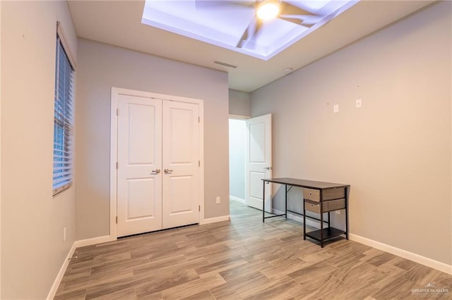 interior space featuring hardwood / wood-style flooring, ceiling fan, and a closet