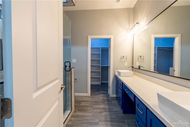 bathroom with walk in shower and vanity