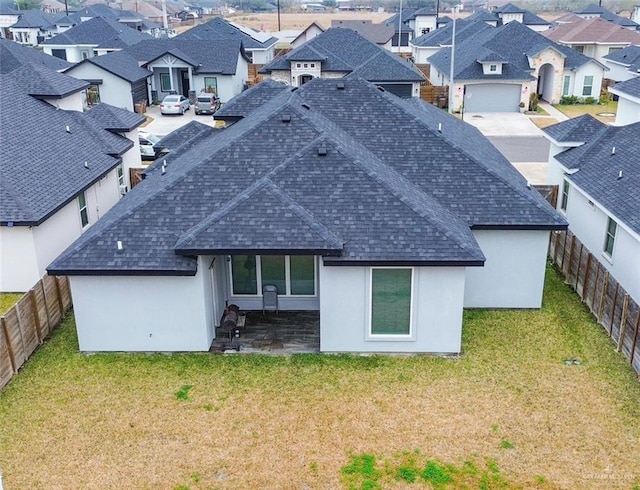 rear view of property with a lawn