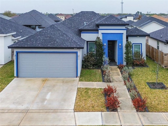 view of front of house with a garage and a front lawn