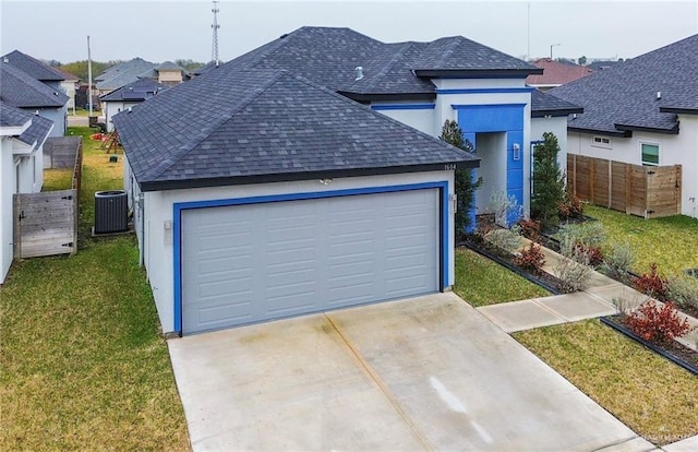 garage with a yard and cooling unit