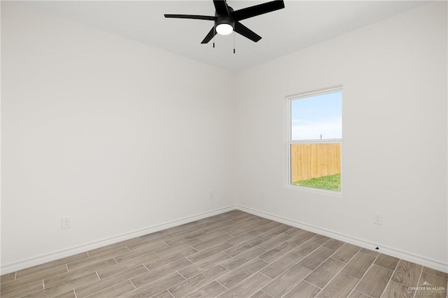 spare room featuring light hardwood / wood-style flooring and ceiling fan