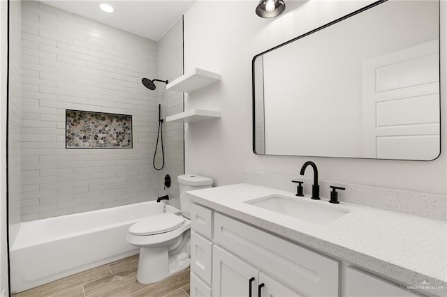 full bathroom featuring vanity, toilet, and tiled shower / bath