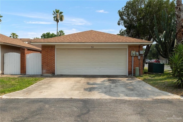 301 E Ln Vista Ave Unit Ut26, Mcallen, TX 78501 - view of front facade with brick siding, a garage, central AC unit, and a shingled roof