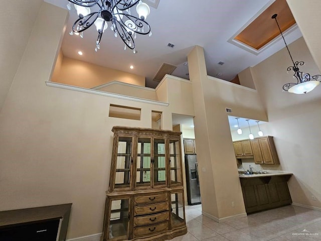 3109 S Casa Linda St, Mcallen, TX 78503 - dining room with baseboards, light tile patterned floors, a chandelier, and a towering ceiling
