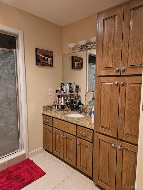 3109 S Casa Linda St, Mcallen, TX 78503 - full bath featuring a shower stall, tile patterned floors, and vanity