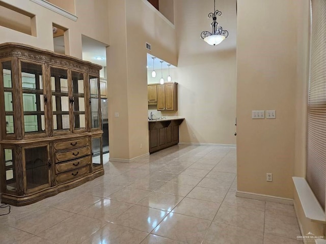3109 S Casa Linda St, Mcallen, TX 78503 - foyer entrance featuring baseboards, a towering ceiling, and light tile patterned floors