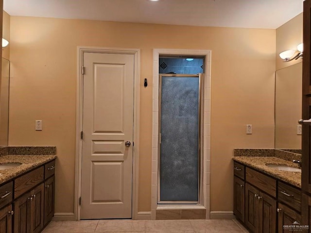 3109 S Casa Linda St, Mcallen, TX 78503 - bathroom with a stall shower, two vanities, tile patterned floors, and baseboards
