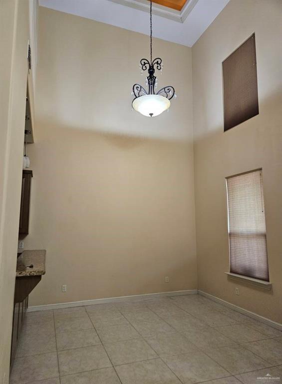 3109 S Casa Linda St, Mcallen, TX 78503 - unfurnished room featuring a towering ceiling, light tile patterned floors, and baseboards