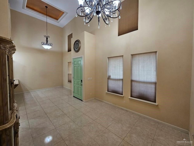 3109 S Casa Linda St, Mcallen, TX 78503 - foyer with a towering ceiling, a chandelier, light tile patterned floors, and baseboards