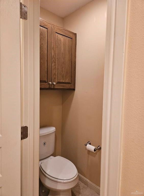 3109 S Casa Linda St, Mcallen, TX 78503 - bathroom featuring toilet, baseboards, and tile patterned flooring