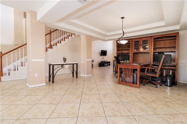 office featuring tile patterned flooring and a tray ceiling