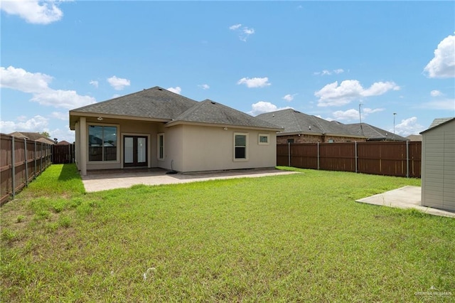 rear view of property with a yard and a patio