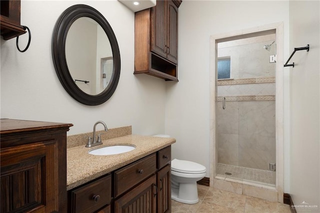 bathroom with vanity, toilet, and a shower with shower door