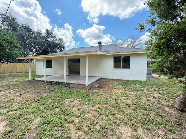 rear view of property with a patio area and a yard